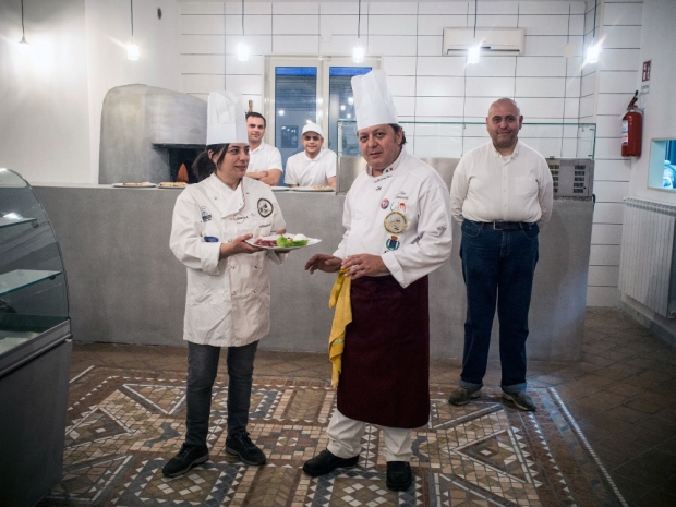 The cooks of Nuova Cucina Organizzata inside the restaurant in Casal di Principe, Caserta